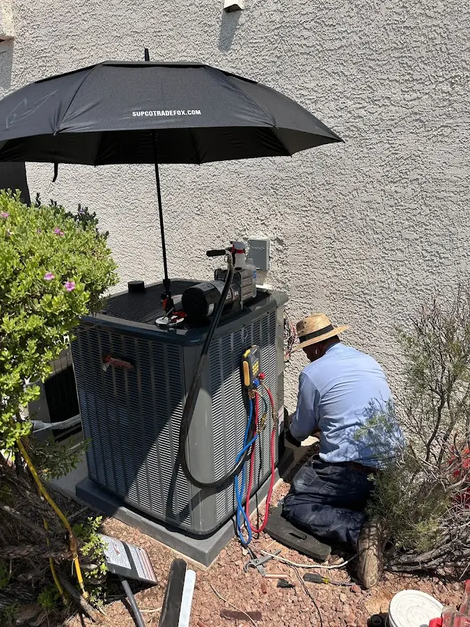 HVAC technician performing outdoor AC maintenance in Monahans